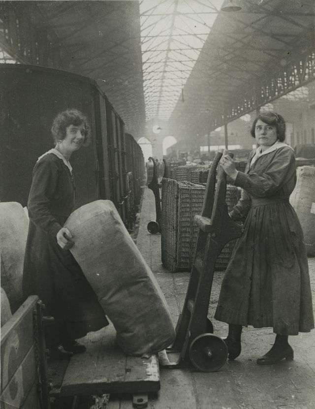 Railway workers unloading goods from a train.