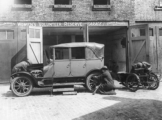 A woman mechanic repairing a car at a Women's Volunteer Reserve garage.