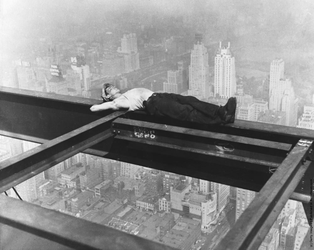 A workman takes a siesta on a girder during the building of Radio City, New York City, 1933.