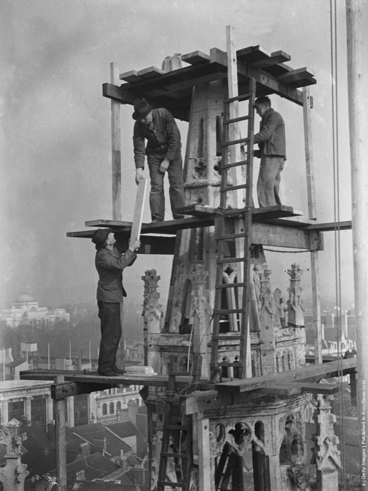 Workmen on scaffolding at the top of the spire of St Johns church in Cardiff carrying out repairs, 1937.