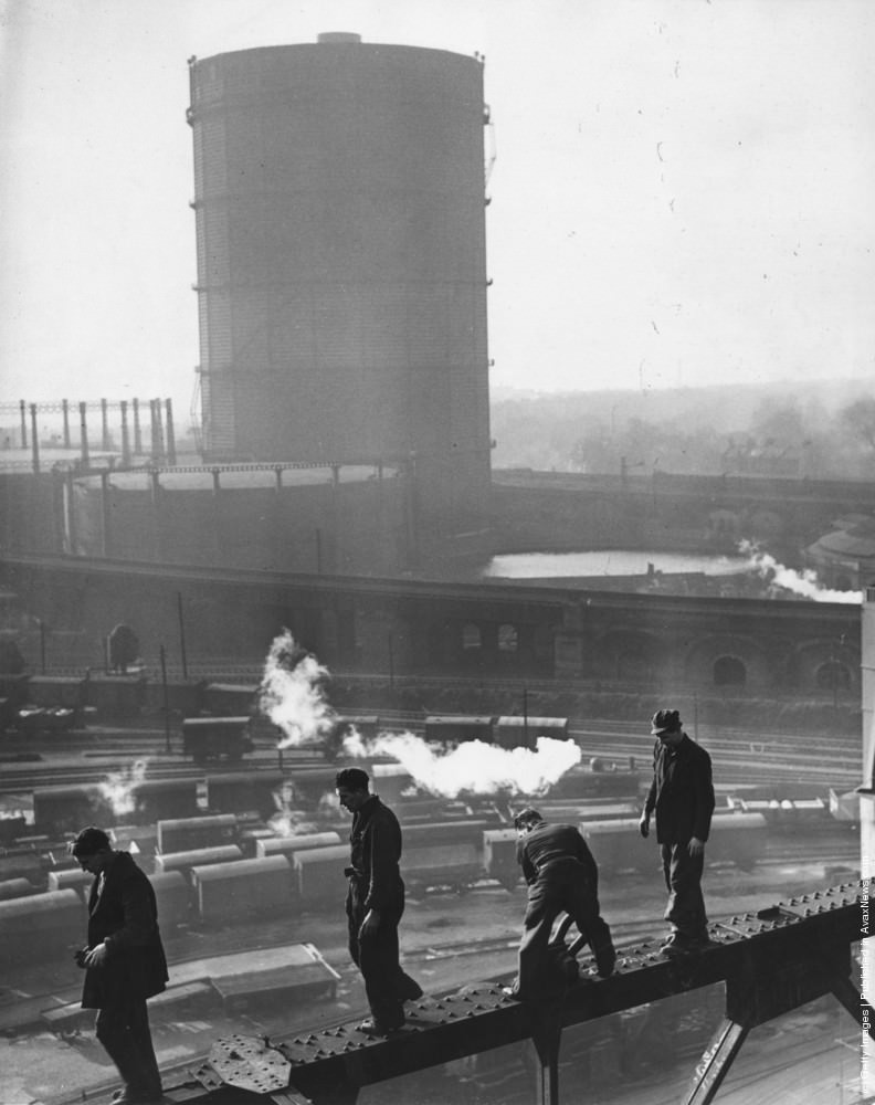 Men at work on Battersea Power Station walking along a narrow girder, 1951.