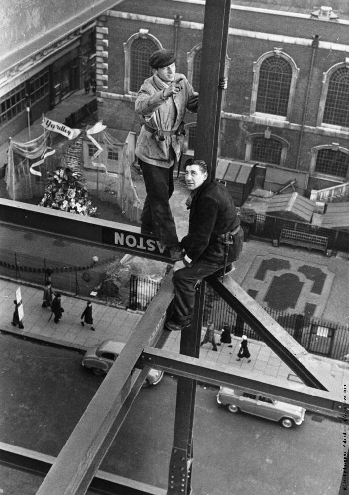 A steel construction worker crosses a steel girder, 1955.