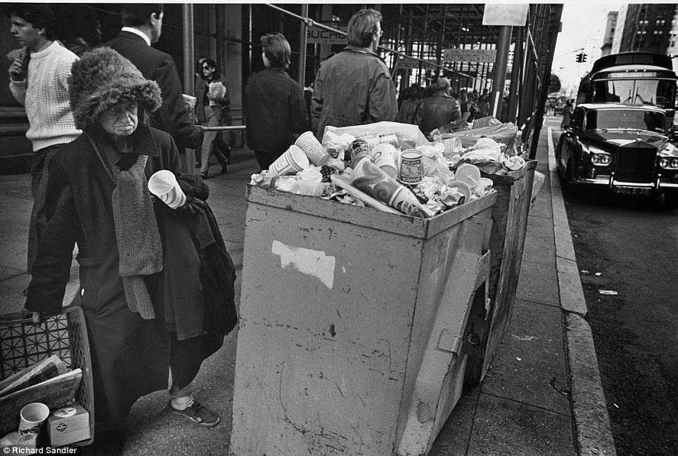 A homeless woman stands near overflowing trash on Fifth Ave, 1980.