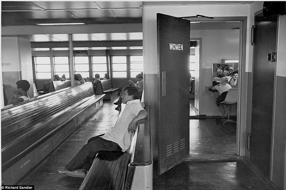 Inside the women's room on the Staten Island Ferry, a woman slumps in front of the mirror, 1978.