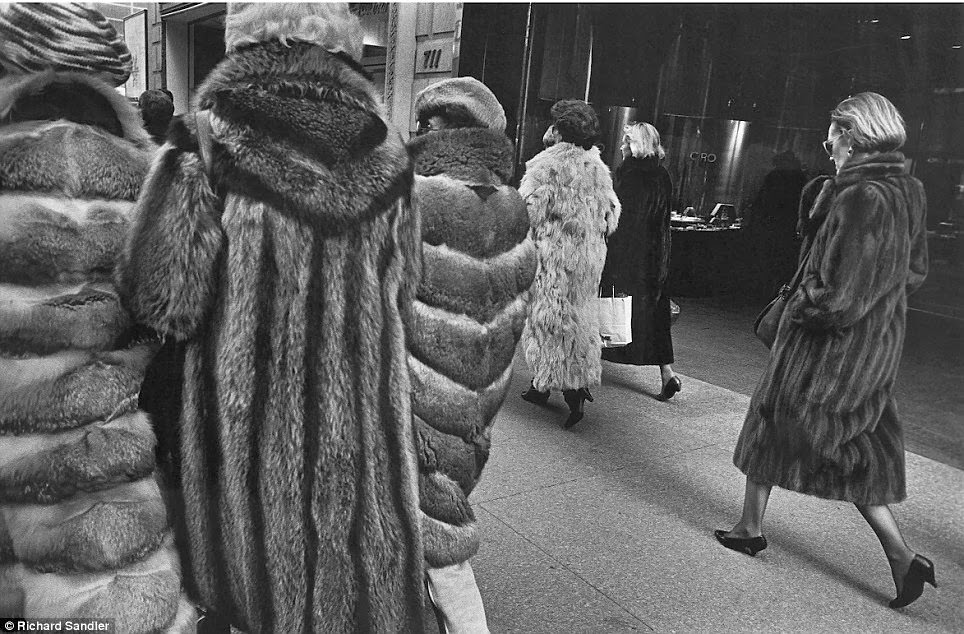 Women stalk Manhattan's Fifth Avenue clad in expensive fur coats, 1987.