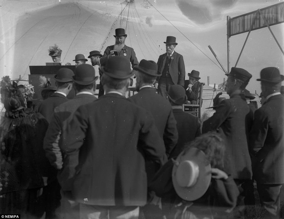 A little girl looses her hat, while men in bowlers listen to a speech at the Temperance Festival on the Town Moor, Newcastle.