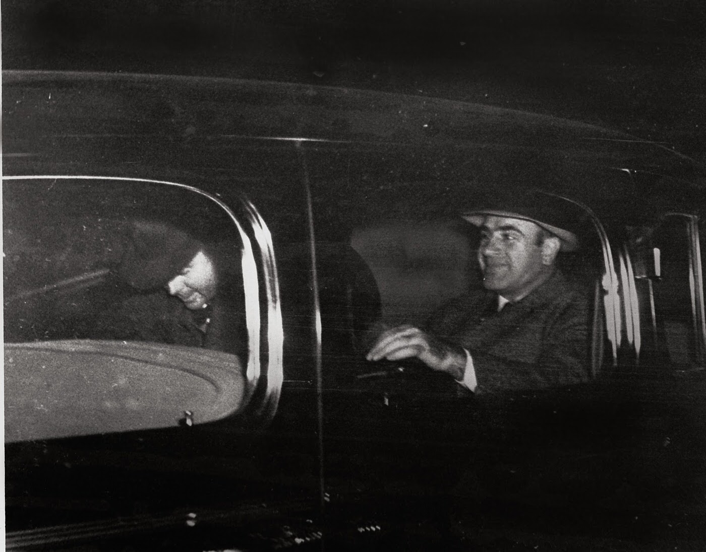 Al Capone leaving Harrisburg, Pa. with a federal officer for Lewisburg, Pa., after spending seven years in prison, November 16, 1939.