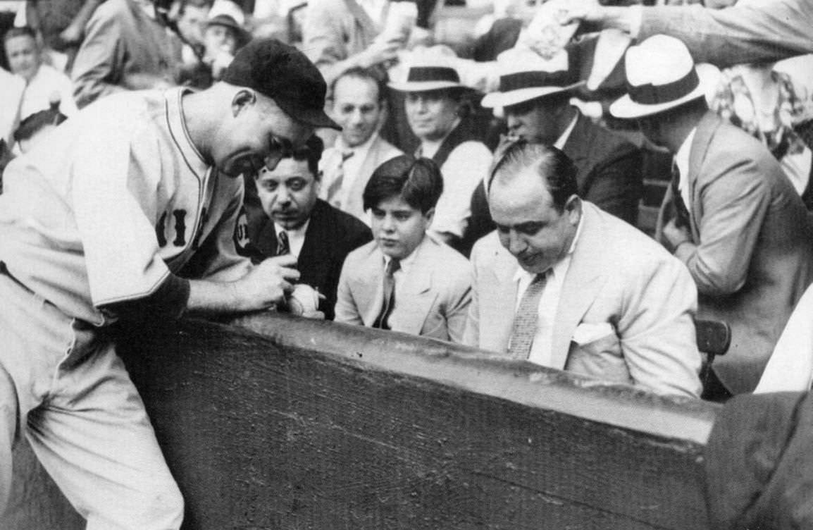 Al Capone and his son Albert Capone with a baseball signed by Chicago Cubs player Gabby Hartnett, 1931.