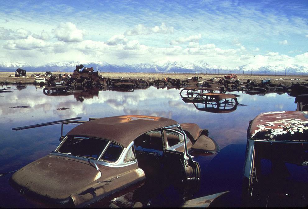 Abandoned automobiles and other debris clutter an acid water and oil-filled five acre pond near Ogden, Utah, which was cleaned up under EPA supervision, 1974.