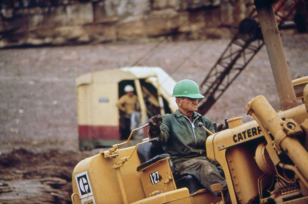 Dragline and workers at the site of an oil spill cleanup on the San Juan River in Monument Valley, Utah, 1972.