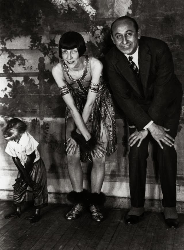 A monkey doing the 'Charleston' alongside a couple of dancers, 1922.