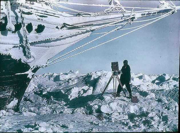 Frank Hurley photographing under the bows of the 'Endurance', 1915.