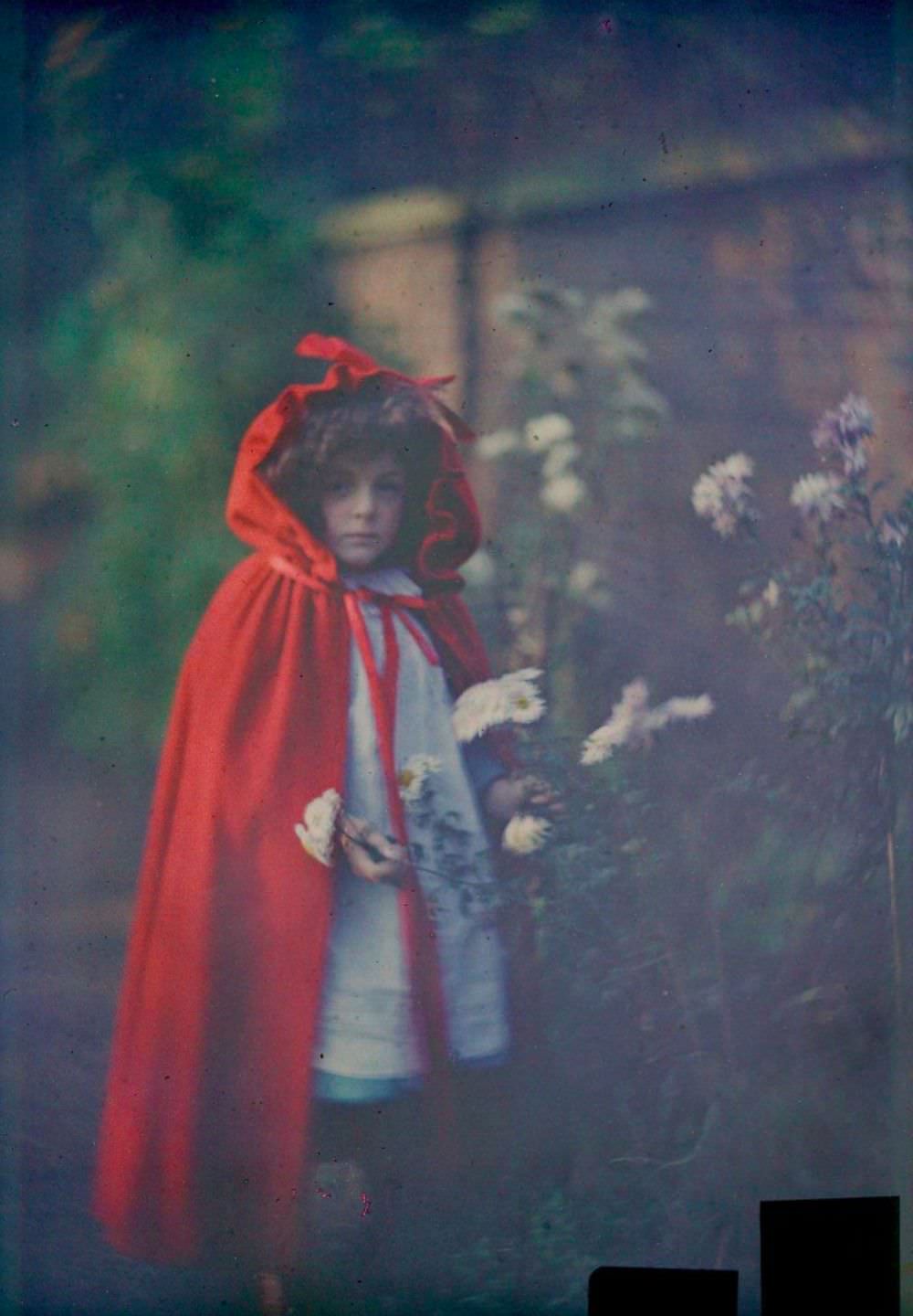 Joan in red riding hood cape with basket, 1907