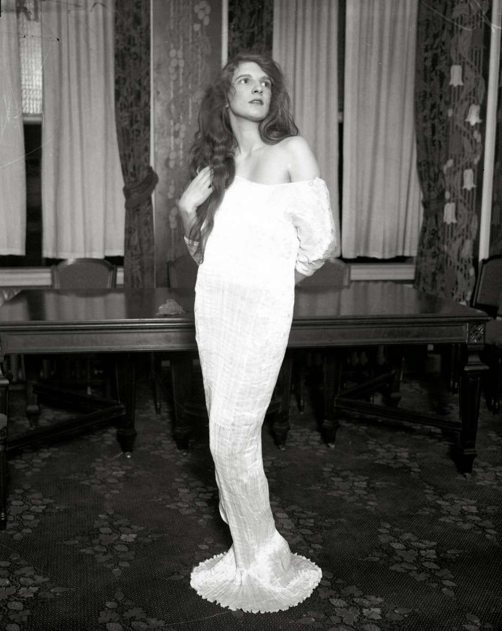 Mrs. Wallace Ford models a dress that she will wear to the Miss America costume for arts ball at the Stevens Hotel, 1927.