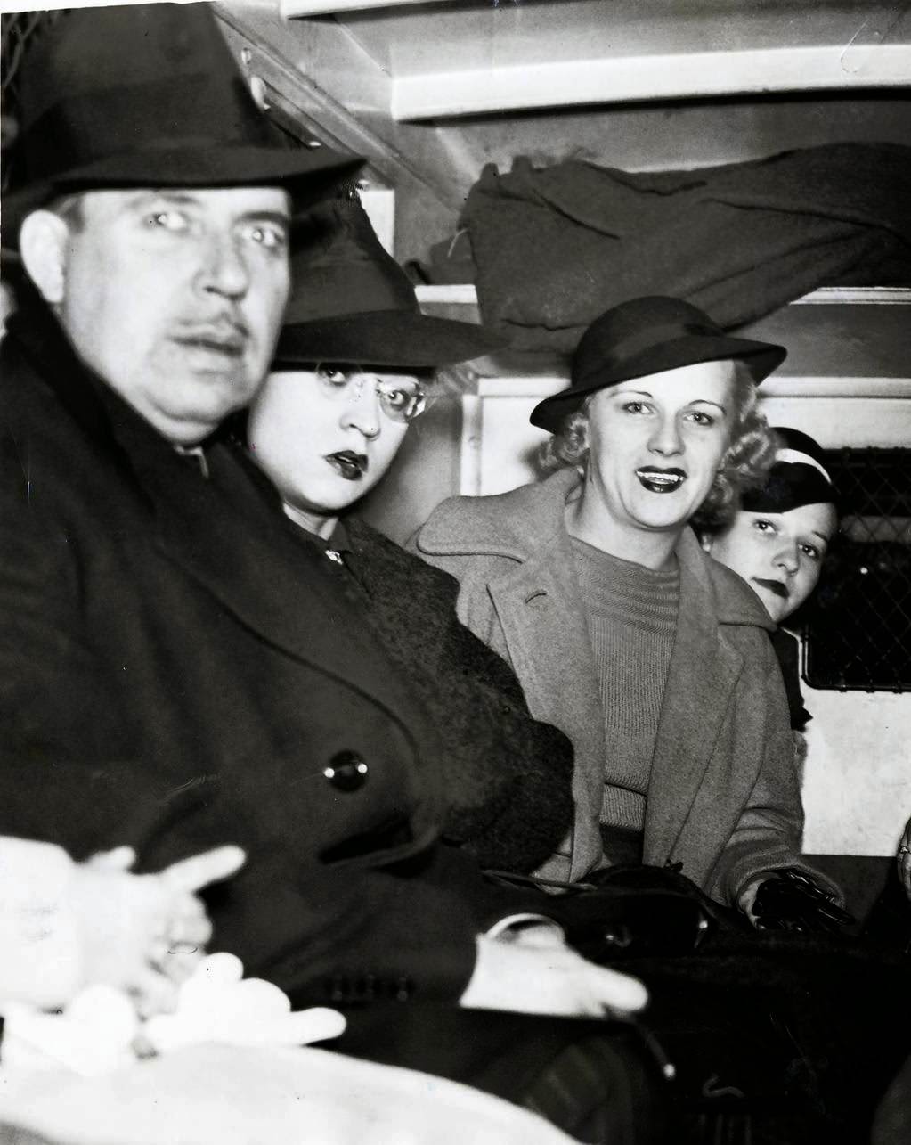 An arrested man and three women sit in the back of a police wagon following a vice raid on the Rialto Theatre on Oct. 17, 1937. Twenty-two women and 10 men were arrested in the surprise raid at the theater and charged with presenting or participating in indecent exhibitions. All arrested were released on $125 bail. In total 70 men and 45 women were arrested in the surprise raids across the city.