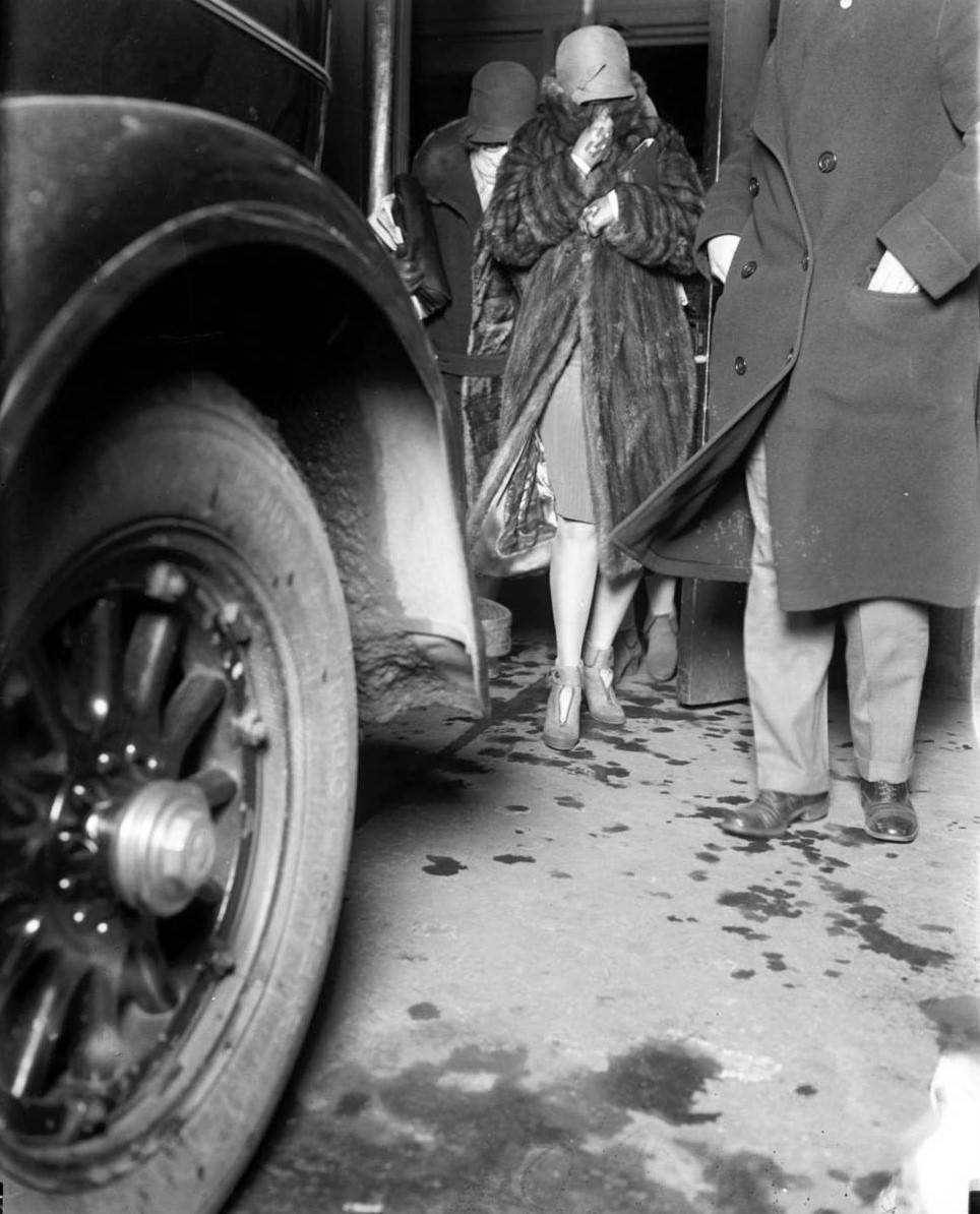 Mrs. Myrtle Gorman, center, of 434 Roscoe Street, was the wife of Peter Gusenberg, a gang leader for George "Bugs" Moran. Gusenberg, 40, was murdered when rival Capone-backed gangsters mowed him and six companions down in a North Clark Street garage on Feb. 14, 1929. Mrs. Gorman, who denied all knowledge of her husbands activities, is leaving the Gusenberg inquest on Feb. 14, 1929. The murders became known as the St. Valentine's Day Massacre.