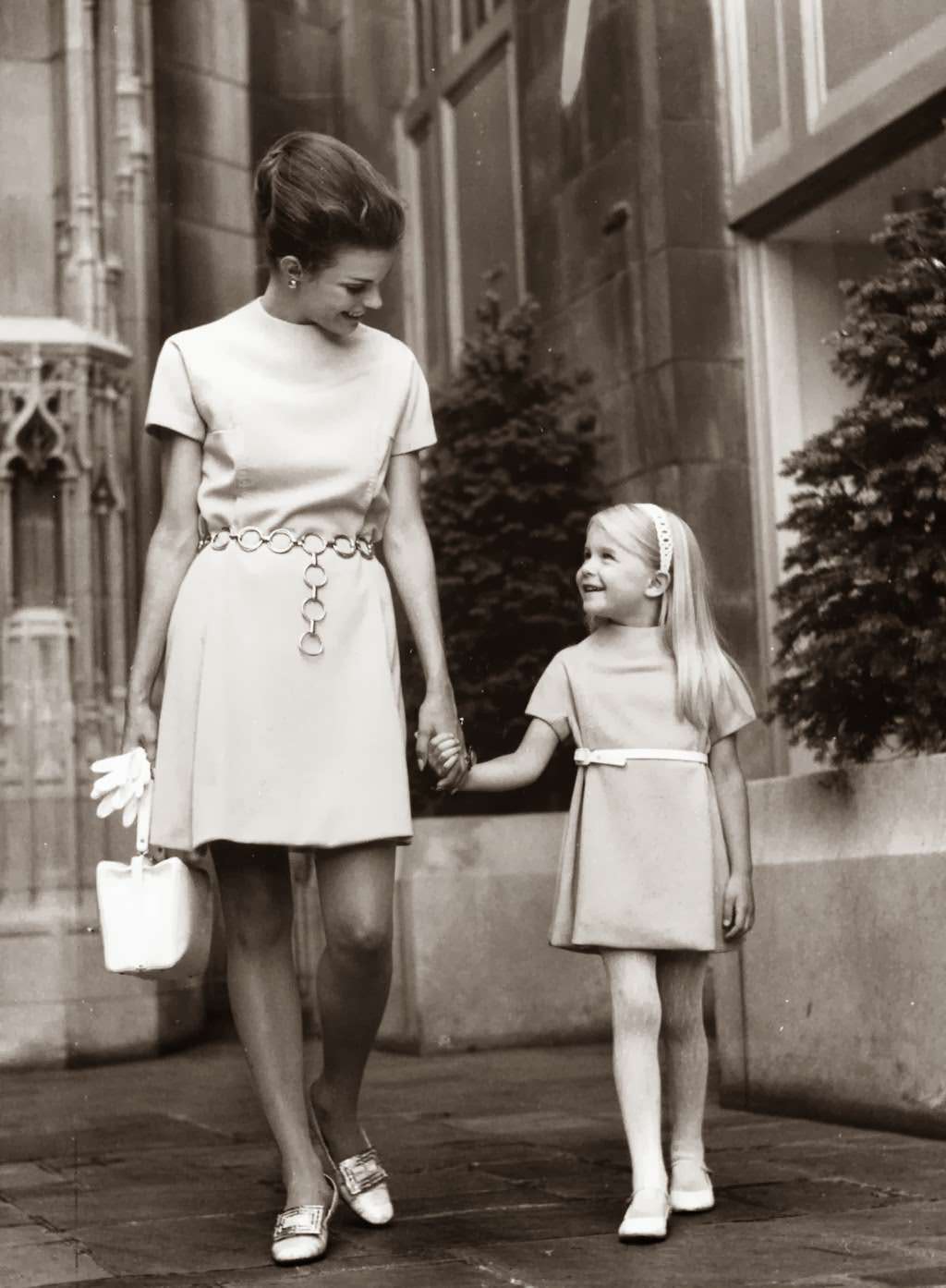 "Mother chose not to accent an empire waist in her dress No. 8383, instead used a smart chain belt at the normal waistline. Daughter's dress, identically styled, is made from pattern No. 8384." — Earl Gustie, Chicago Tribune, July 17, 1968