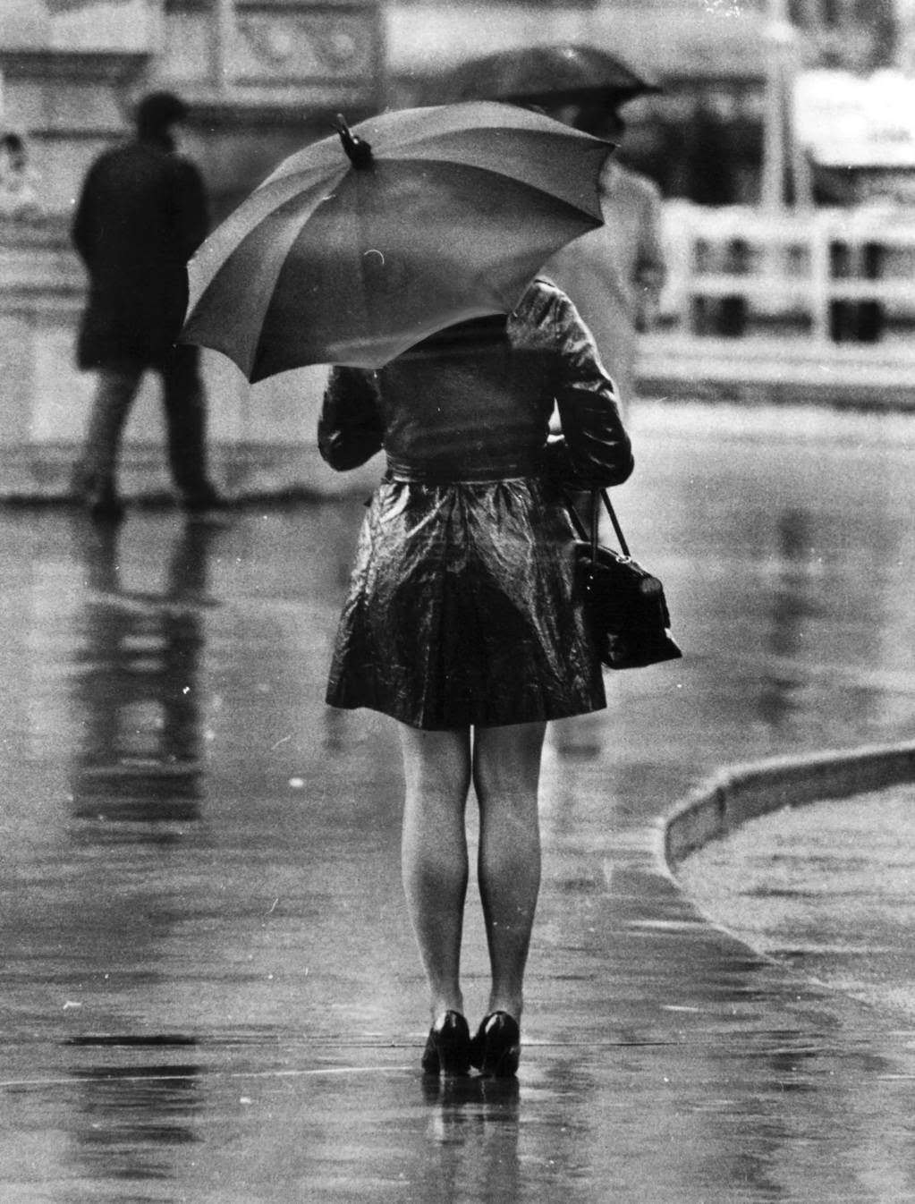 "A windswept rainy fall day in Chicago, but fashion prevails come wind or high water. Only the maxi-coat seems to offer protection from the elements, but the attention of girl-watchers makes the mini the choice of most young women." — Jack Mulcahy, Chicago Tribune, Nov. 3, 1969