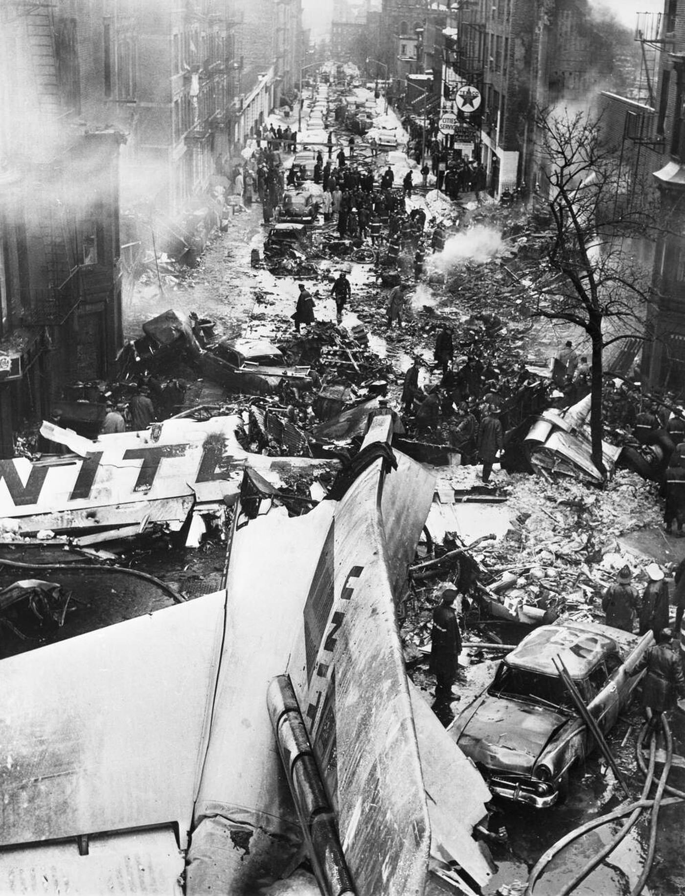 The tail-plane and wing of the United Airlines Douglas airliner lies in the middle of a street in residential Brooklyn after colliding mid-air with a TWA Constellation airliner; at least 132 people died in the disaster, December 1960.