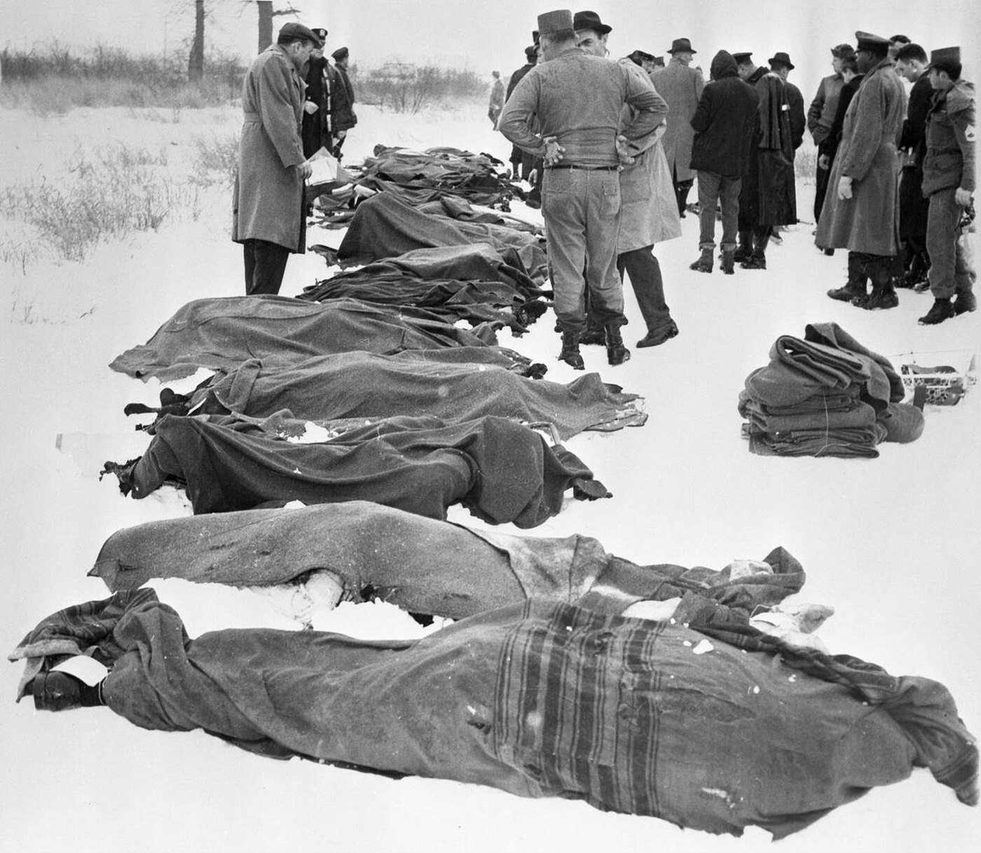Blanketed bodies lie on the snow after a United Airlines Douglas airliner collided mid-air with a TWA Constellation airliner; at least 132 people died in the disaster, December 1960.
