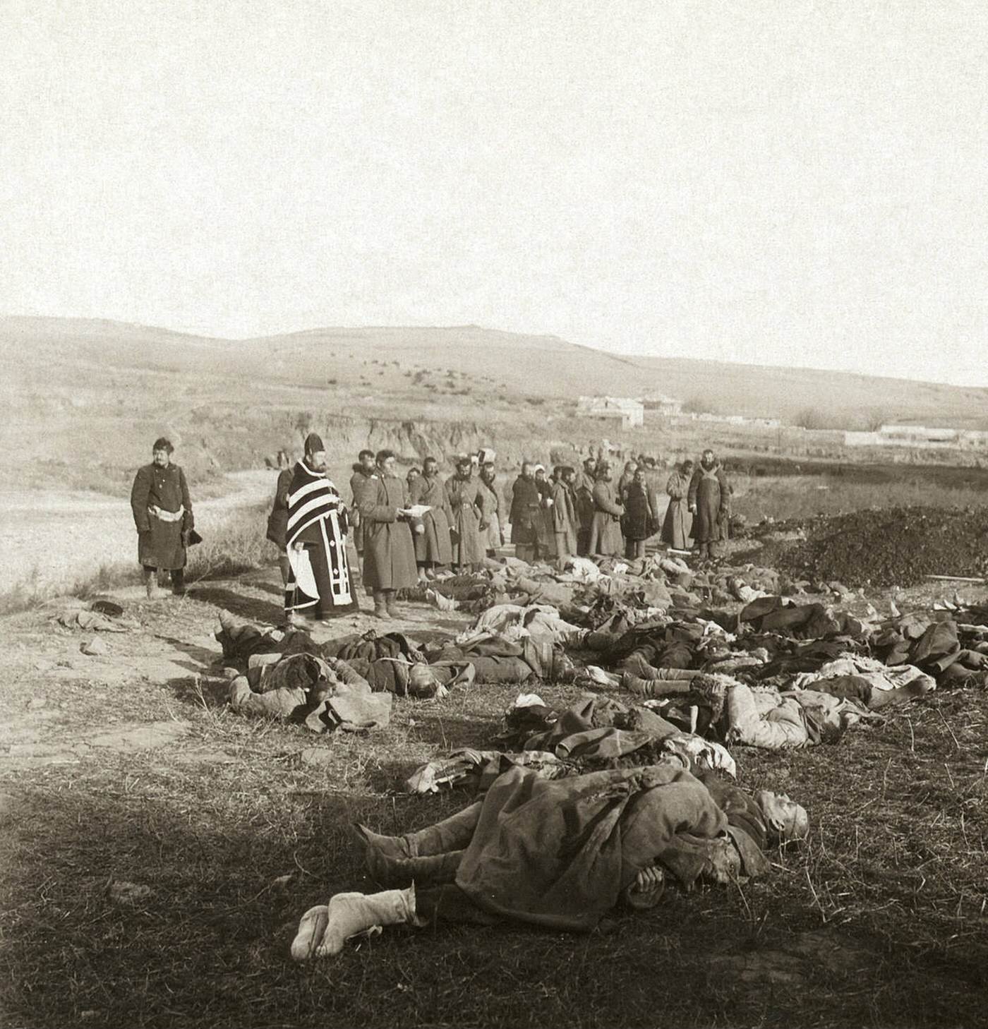 Russian soldiers praying over their dead comrades brought back from the front, Port Arthur, China, 1905.