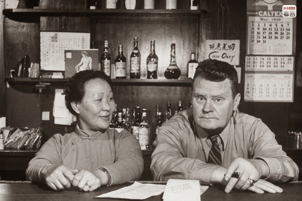 1949 May 1, inside a bar, a photo of American bar owner Frank and his Chinese wife in their bar. This was several days before Communist Party forces reached Shanghai.