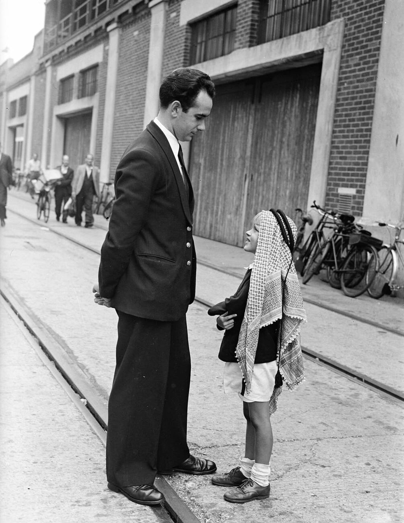 [Factually Corrected] Tweedie Roosevelt, wearing the national head-dress of Syria, waits to board the "Caronia" to sail for Long Island, New York, 1949.