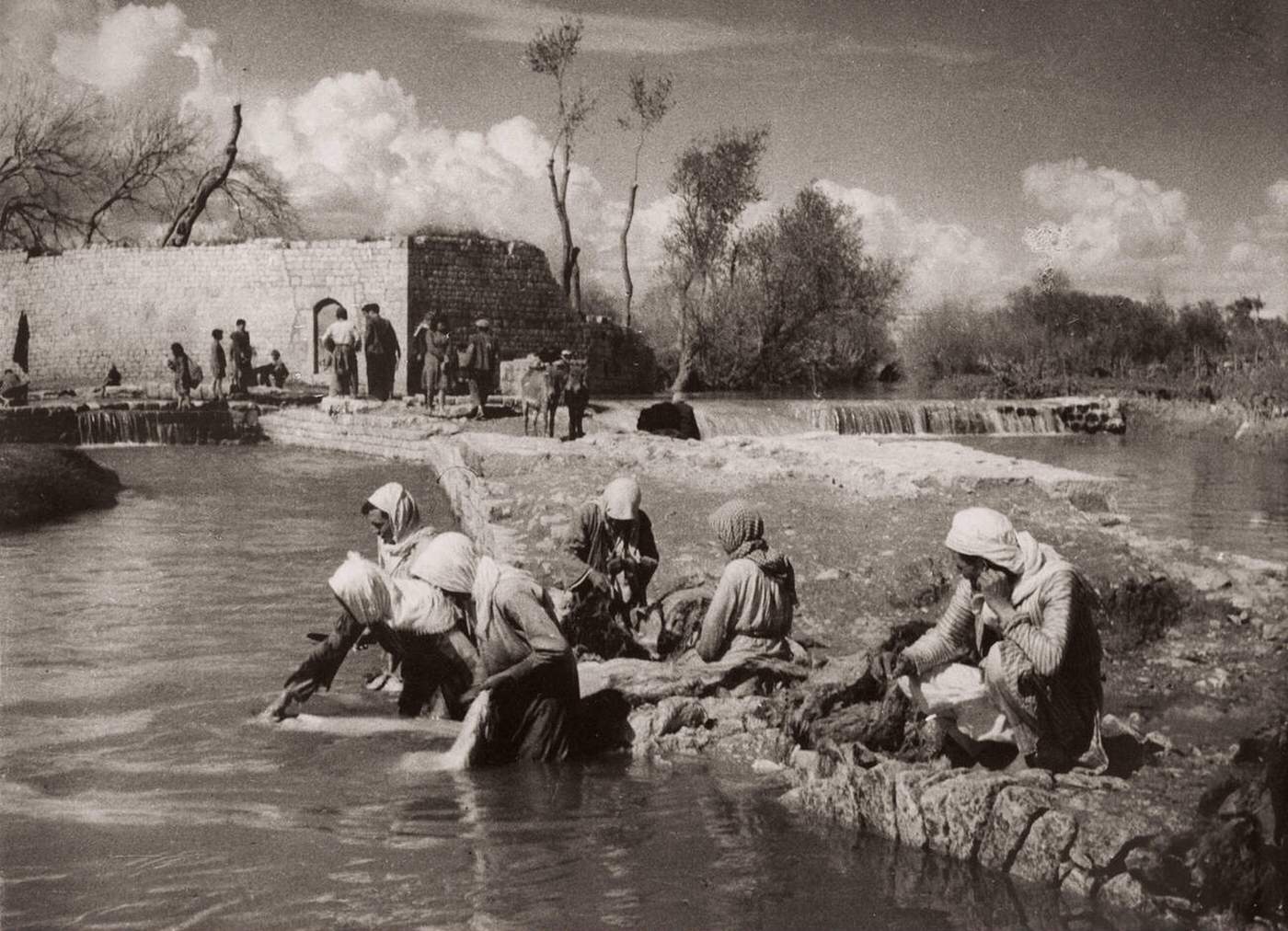 Women washing clothes in a river in Aleppo, Syria, 1943.