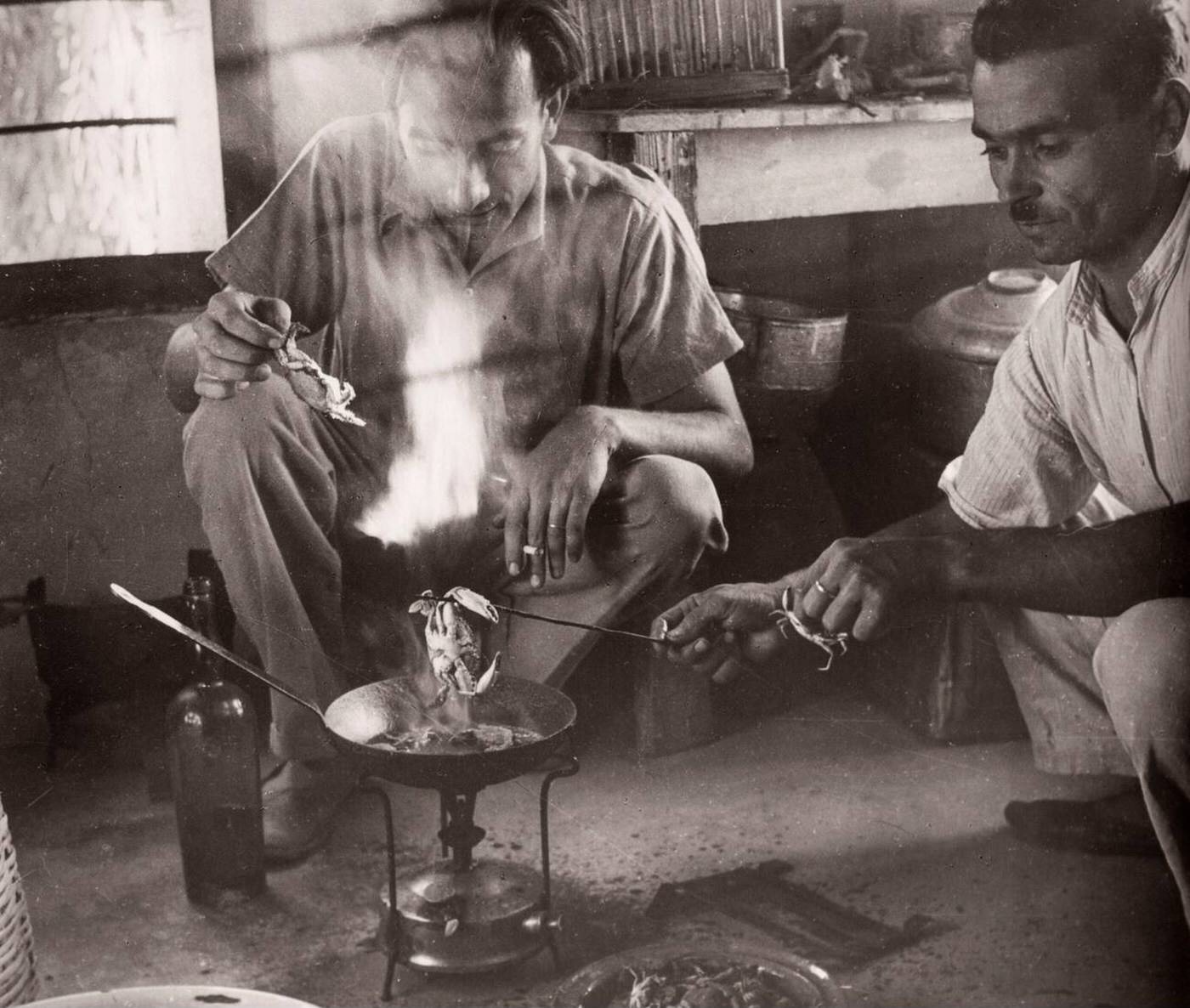 British soldier cooking sand crabs, Syria, 1943.
