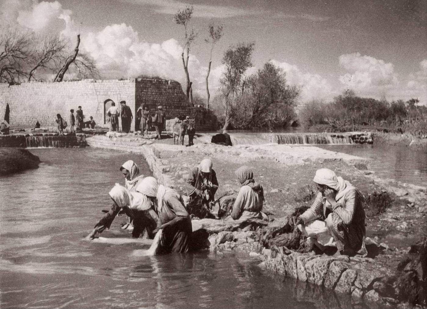 Women washing clothes in a river in Aleppo, Syria, 1943.