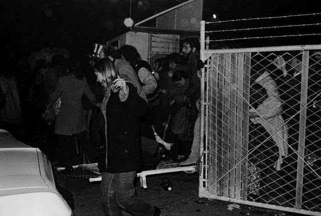 Eager rock fans storm the gate at Altamont Speedway well in advance of the scheduled opening for a free rock festival featuring the Rolling Stones, 1969.