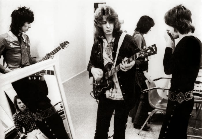 Keith Richards, Mick Taylor & Mick Jagger of the Rolling Stones warming up backstage, 1969.