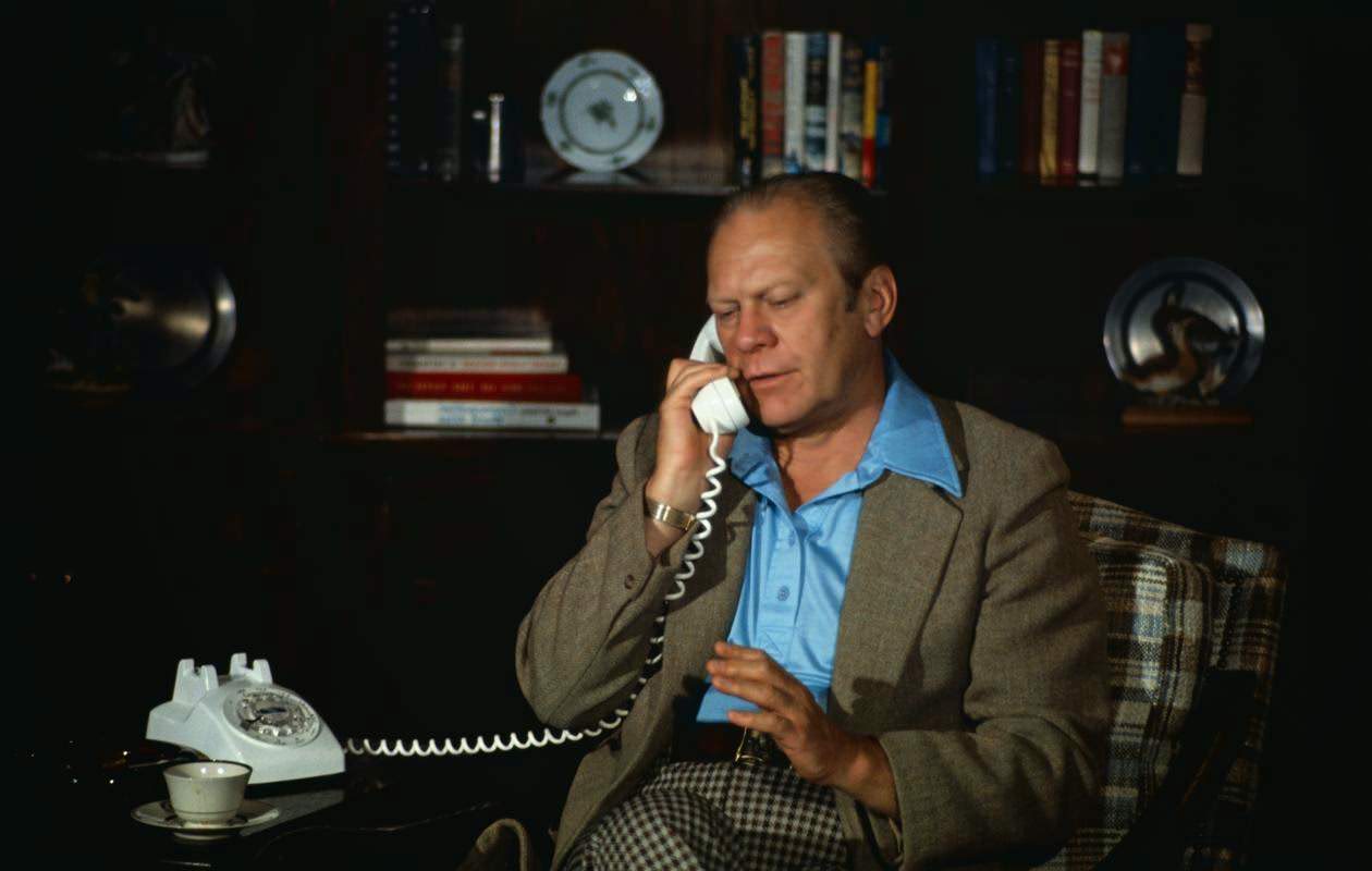 President Gerald Ford speaks by phone to Henry Kissinger on Middle East agreement at Camp David, MD, 1975.