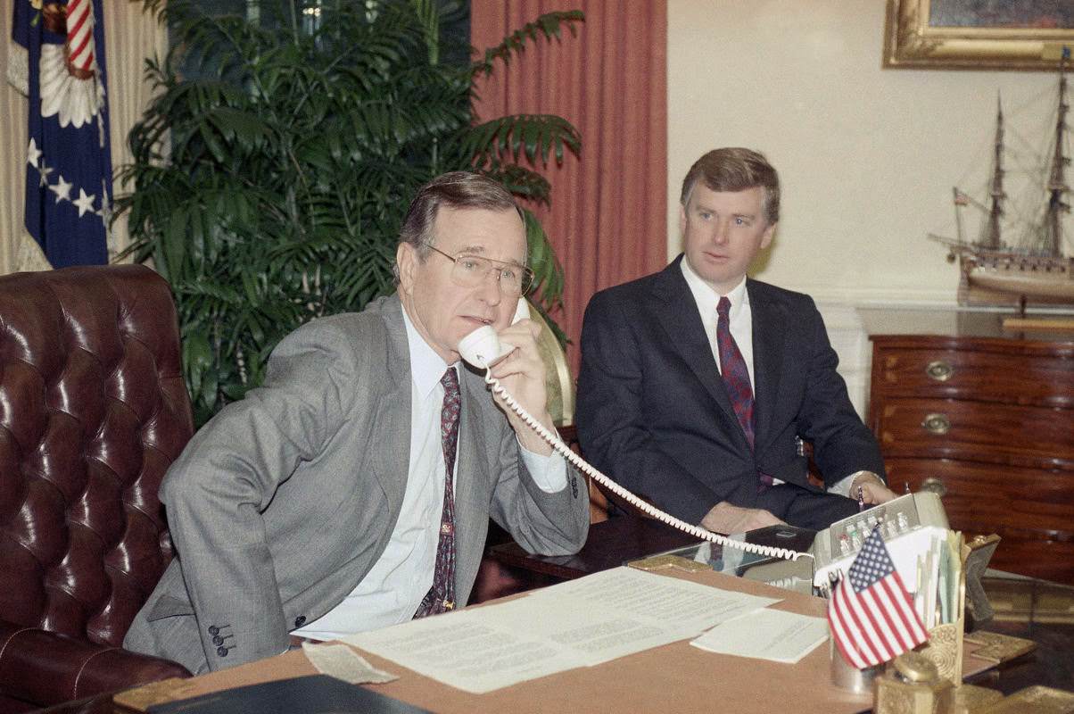 President George H. W. Bush speaks to the orbiting Columbia astronauts with Vice President Dan Quayle from the Oval Office, Washington, D.C., 1989.
