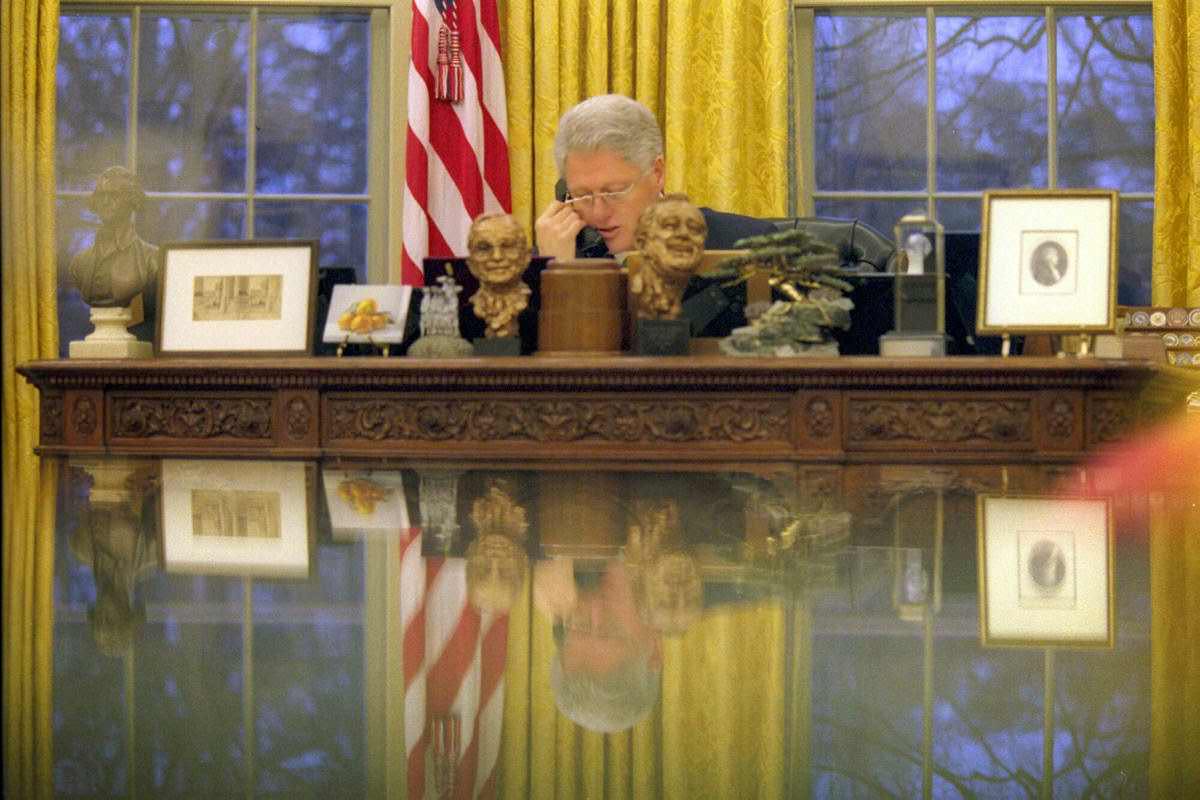 President Bill Clinton talks on the telephone in the Oval Office in the White House in Washington, 2000.