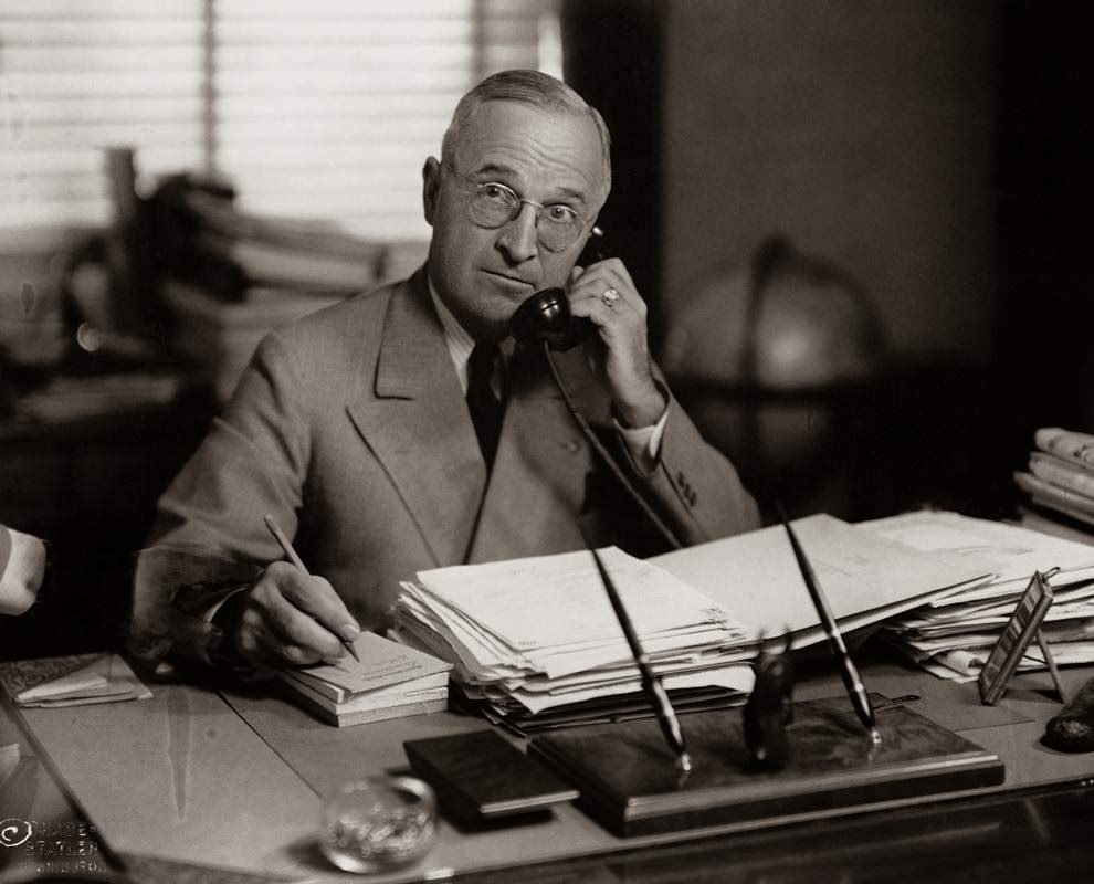 President Harry Truman talks on the telephone in his office in Washington, D.C., 1945.