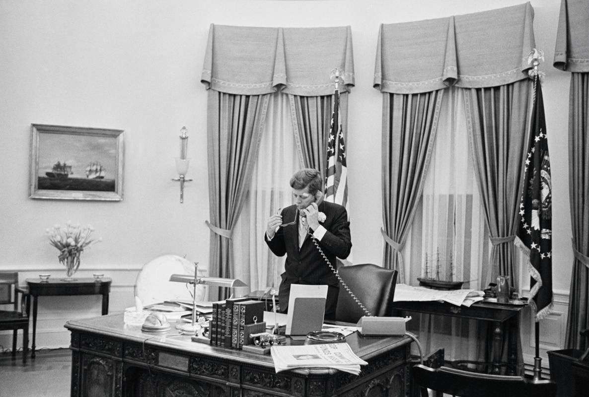 President John F. Kennedy talks on the telephone in the Oval Office, 1961.