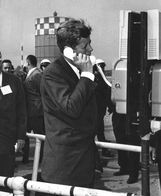 President John F. Kennedy takes a telephone call at a special installation at Detroit's City Airport, 1962.