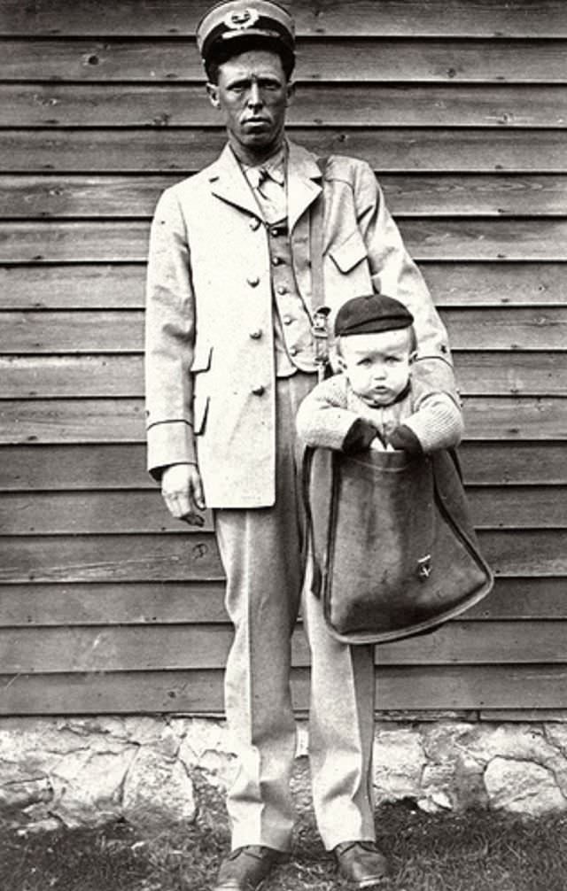 A letter carrier with a mailed baby, circa 1916.