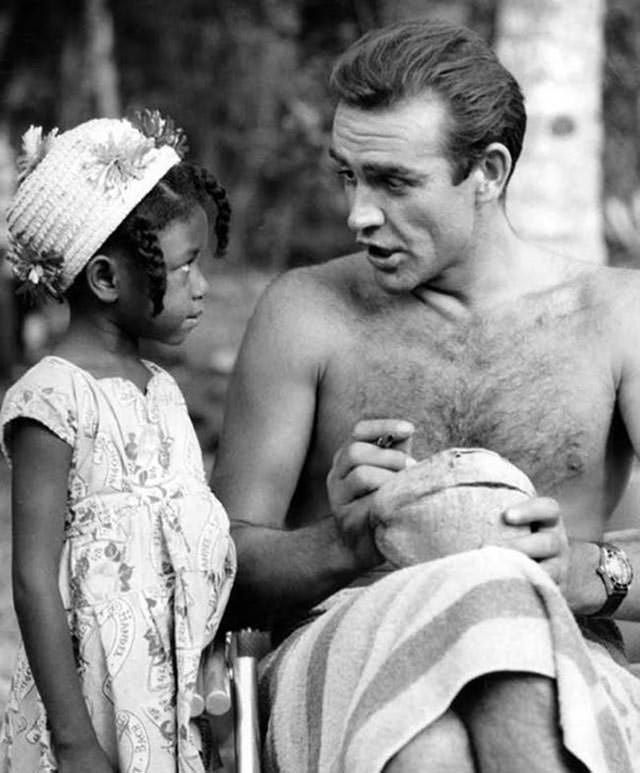 Sean Connery signing a coconut for a little Jamaican fan on the set of Dr. No, 1962.