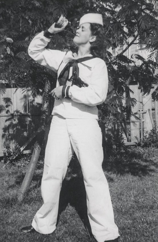 Female sailor drinking while embracing the other beer bottles.