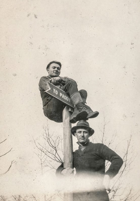 Man climbing a street sign.