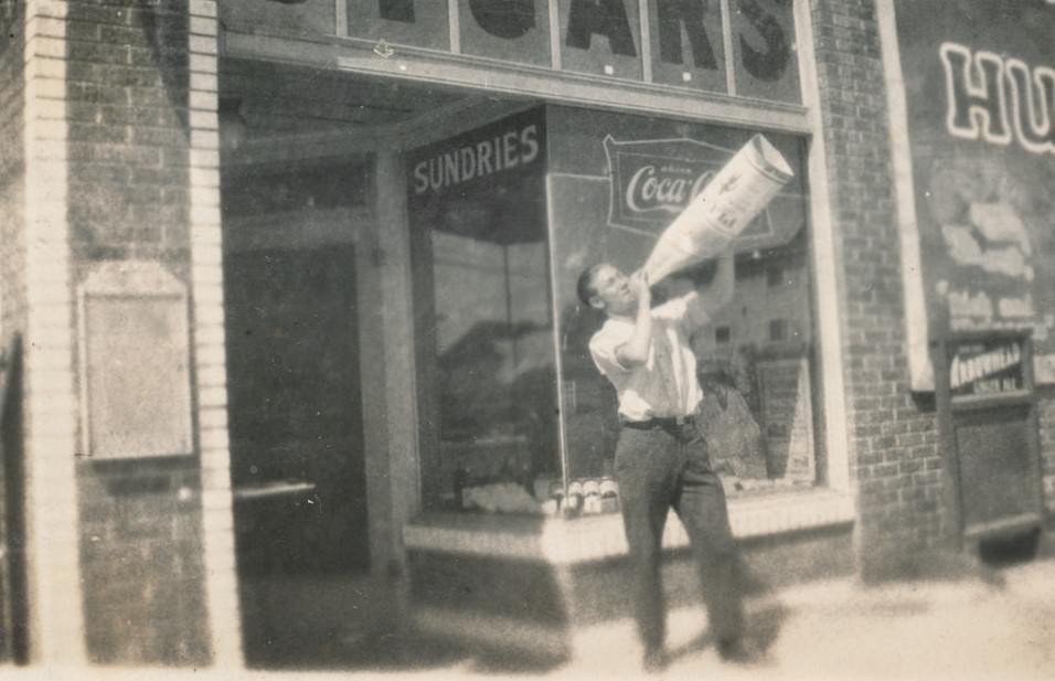 Man drinking from a huge bottle.