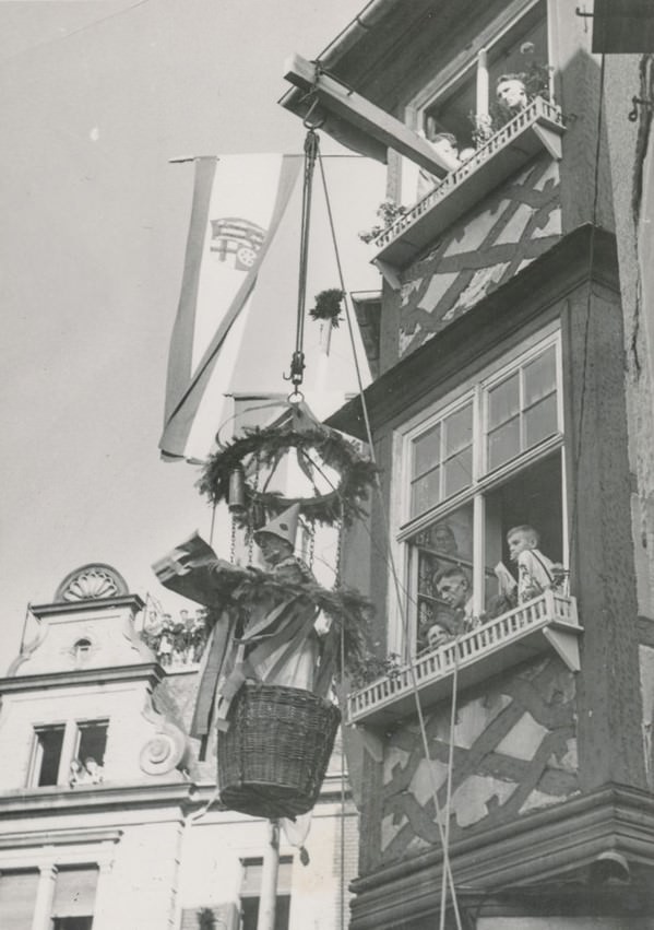 Man suspended in a basket as part of a celebration.
