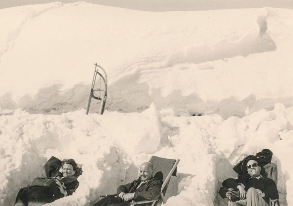 People relaxing in a snow drift.