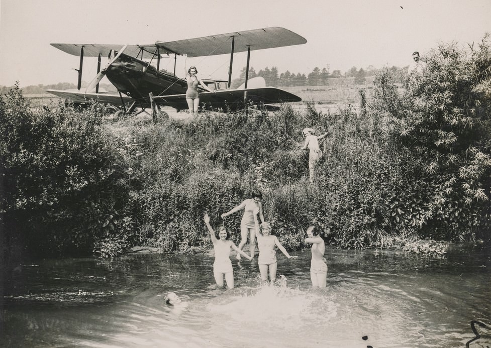 Women go swimming at the lake by plane.