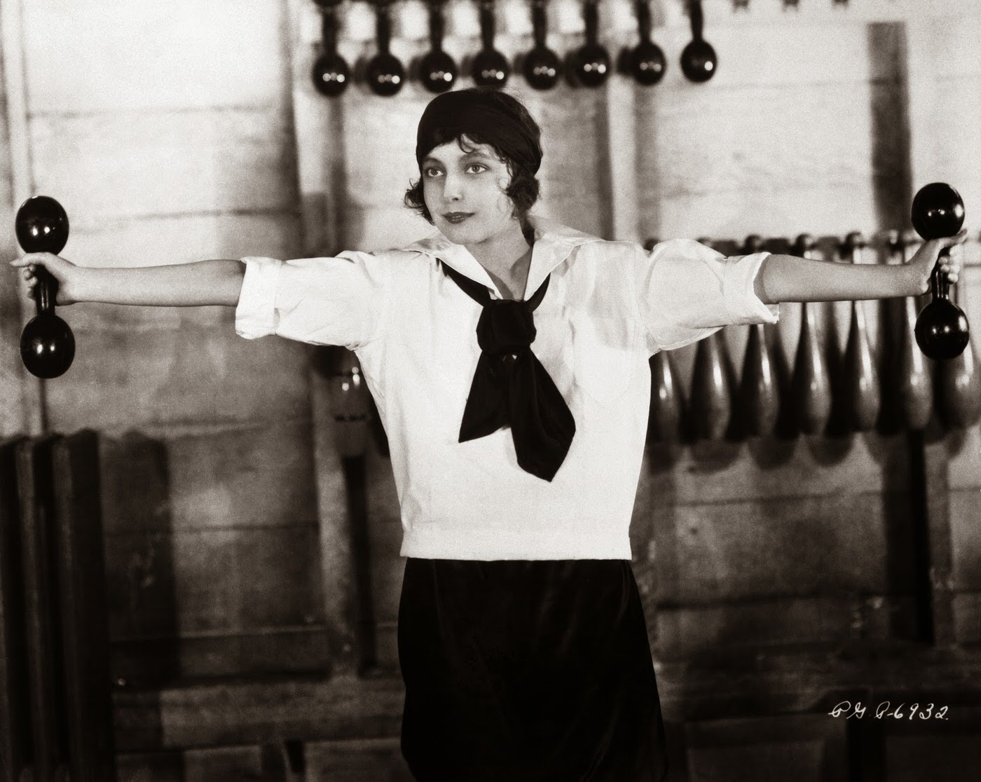 Woman exercising with dumbbells, ,1920s.