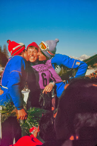 American skier Jean Saubert (center) gets kisses from French downhill gold and silver medalists (and sisters), Christine and Marielle Goitschel, Innsbruck Olympics, 1964