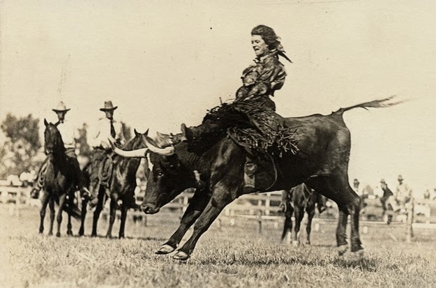 Mildred Douglas Chrisman, an early cowgirl and stunt woman, rides a bull, 1930.
