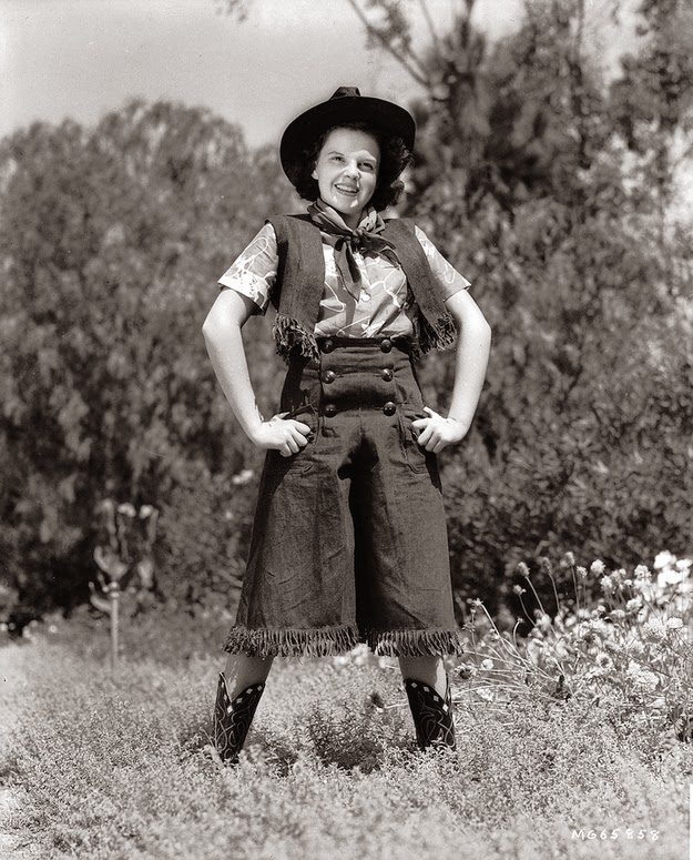 Judy Garland dressed as a cowgirl.